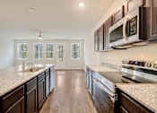 Thumbnail 25 of 30 - Granite countertops and stainless steel appliances