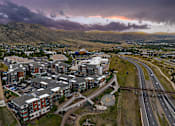 Thumbnail 27 of 28 - A large apartment complex is located next to a busy highway.