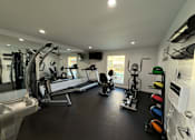 Thumbnail 16 of 17 - A well-equipped gym with a variety of exercise machines.