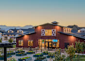 Thumbnail 18 of 29 - A barn-like building with a red and white exterior and a large X on the front.