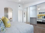 Thumbnail 15 of 28 - a bedroom with a bed and a mirror