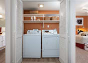 Thumbnail 17 of 28 - a laundry room with a washer and dryer