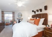 Thumbnail 11 of 28 - a bedroom with a bed and a ceiling fan