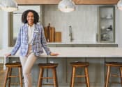 Thumbnail 9 of 29 - a woman sitting on a counter in a kitchen