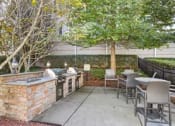 Thumbnail 11 of 21 - a patio with a hot tub and tables and chairs