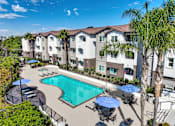 Thumbnail 2 of 31 - A sunny day at the pool of a residential building.