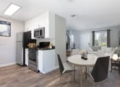 Thumbnail 11 of 15 - a kitchen and dining area in a 555 waverly unit