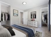 Thumbnail 13 of 15 - a bedroom with a bed and a dresser