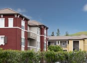 Thumbnail 10 of 17 - a row of apartment buildings with a mountain in the background