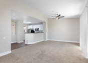 Thumbnail 7 of 17 - an empty living room with a ceiling fan