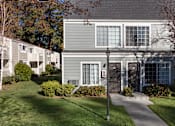 Thumbnail 31 of 32 - a house with gray siding and a light pole in front of it
