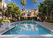 Thumbnail 6 of 24 - A pool with a reflection of a building in the water.