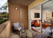 Thumbnail 17 of 27 - Balcony with two chairs and a table and a sliding glass door at Ascend2300, Carlsbad