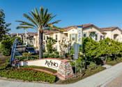 Thumbnail 4 of 33 - A VINO sign is in front of a building with a palm tree.