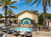 Thumbnail 29 of 33 - A pool area with a mosaic tile wall and lounge chairs.