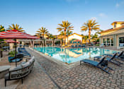 Thumbnail 30 of 33 - A pool surrounded by palm trees and lounge chairs.
