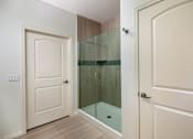 Thumbnail 8 of 33 - A white door is on the left and a glass door is on the right.