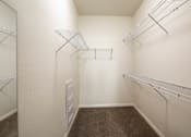 Thumbnail 33 of 33 - A walk-in closet with shelving and a mirror.