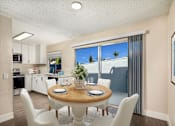 Thumbnail 4 of 22 - A dining room with a table set for two and a view of the backyard.