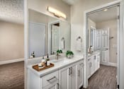 Thumbnail 7 of 22 - A bathroom with a vanity and a mirror.