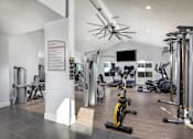 Thumbnail 10 of 22 - A gym with a variety of equipment including treadmills, weights, and exercise bikes.