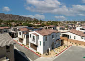 Thumbnail 46 of 47 - an aerial view of a neighborhood of houses with mountains in the background