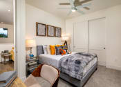 Thumbnail 26 of 47 - a bedroom with a bed and a ceiling fan
