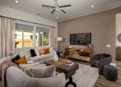 Thumbnail 23 of 47 - a living room with a couch and a chair and a tv