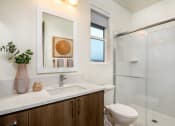 Thumbnail 30 of 47 - a bathroom with a sink and a toilet and a shower