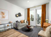 Thumbnail 10 of 48 - a living room with white walls and a sliding glass door that leads to a balcony at VORA LUX, San Diego California