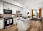 Thumbnail 1 of 48 - a kitchen and living room with white cabinets and a large island with a granite countertop at VORA LUX, San Diego, 92120