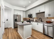 Thumbnail 21 of 48 - a kitchen with white cabinets and stainless steel appliances at VORA LUX, San Diego California