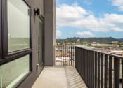 Thumbnail 23 of 48 - a balcony with a view of a city at VORA LUX, San Diego, CA 92120