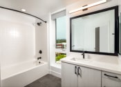 Thumbnail 20 of 48 - a bathroom with a bathtub and a sink at VORA LUX, San Diego, CA