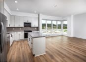 Thumbnail 18 of 48 - an empty kitchen and living room with hardwood floors and a large window at VORA LUX, California