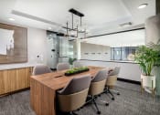 Thumbnail 28 of 48 - a conference room with a long wooden table and gray chairs at VORA LUX, California