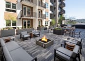 Thumbnail 2 of 48 - an outdoor patio with a fire pit and seating at VORA LUX, San Diego, CA 92120