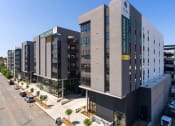 Thumbnail 47 of 48 - a view from above of a large grey building with a green sign on the side of it at VORA LUX, California