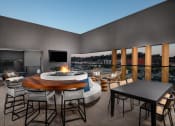 Thumbnail 32 of 48 - a terrace with a fire pit and a table with chairs at VORA LUX, California, 92120