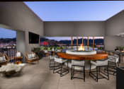 Thumbnail 5 of 48 - a patio with a fire pit and a view of a city at night at VORA LUX, California