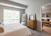 Thumbnail 61 of 68 - A bedroom with a large bed and a dresser.