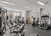 Thumbnail 12 of 21 - a gym with treadmills and other exercise equipment in a building