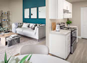 Thumbnail 6 of 33 - Open living room and kitchen space with sofa and coffee table at Canyon Park Apartments, Beaverton