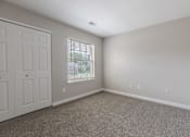 Thumbnail 9 of 19 - an empty room with carpet and a door and window