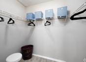 Thumbnail 9 of 24 - A laundry room with a toilet and a clothes drying rack.