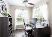 Thumbnail 6 of 24 - A room with a desk, chair, and a fan.