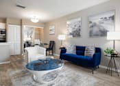 Thumbnail 3 of 24 - A living room with a blue couch and a glass coffee table.