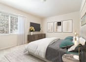 Thumbnail 45 of 55 - A bedroom with a large bed and a window with curtains.