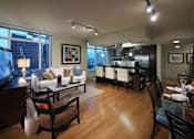 Thumbnail 31 of 41 - A modern living room with a dining area in the background.