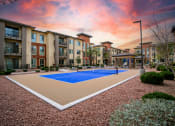 Thumbnail 27 of 34 - an outdoor pickleball court with apartments in the background